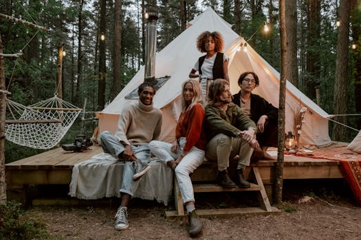 Friends gather for a relaxing glamping trip, embracing the comfort of nature in a forest setting.