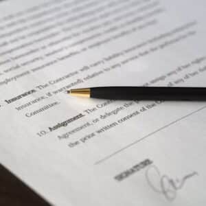 Close-up image of a business contract and pen, signed and ready for agreement.