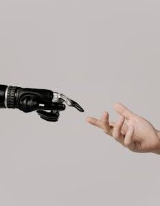 A human hand reaching to touch a bionic prosthetic hand on a white background.